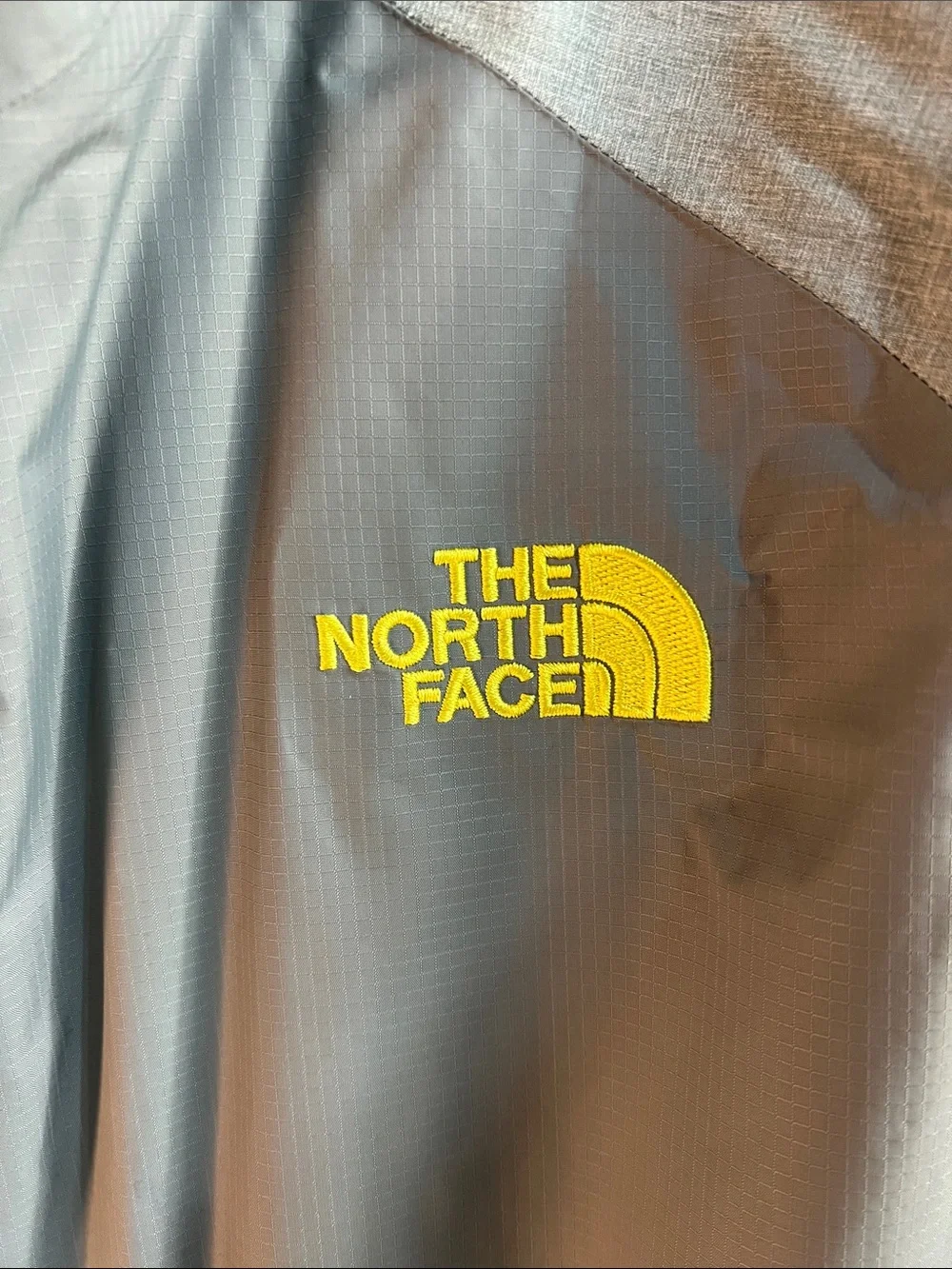 The North Face waterproof men’s XL HyVent 2.5L Shell with Yellow Logo